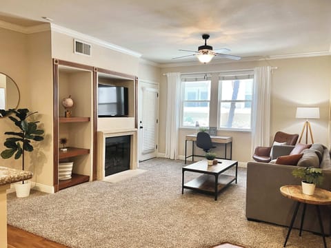 Bright living room with comfortable seating, smart TV, and space to unwind.
