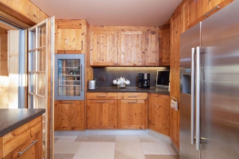 Kitchen including double fridge freezer with ice-dispenser and wine fridge