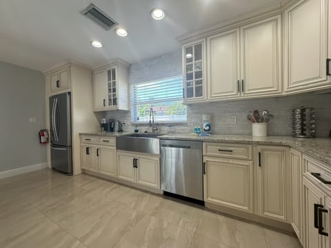 Fully equipped kitchen with refrigerator, stove, microwave, air fryer and more.