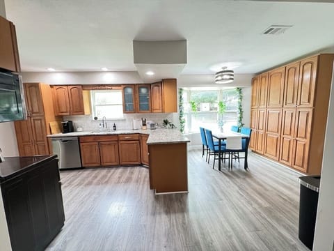 Spacious kitchen equipped with parquet floors and ample cupboards