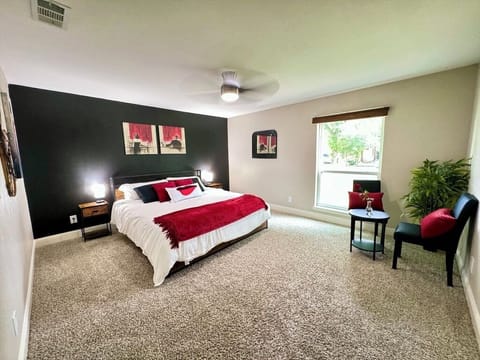 Cozy bedroom with carpeted floors and king-sized bed