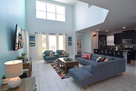 Open-plan living space with doors to the pool deck