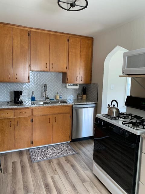 Kitchen with dishwasher, utensils, plates and glasses, coffee maker, 