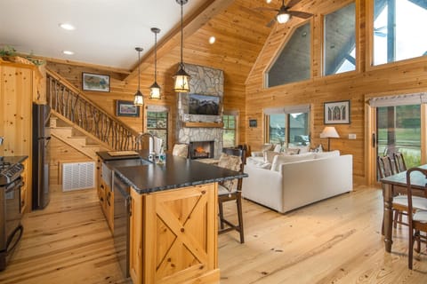 The kitchen is open to the dining and living area and has a gas range.