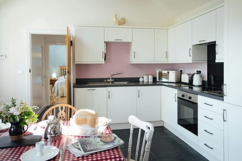 Fitted kitchen/dining area: built-in oven and hob, microwave, kettle and toaster; dining table and chairs