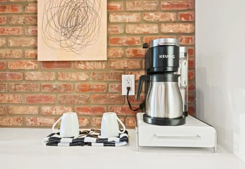 Kick-start your morning with a coffee in our charming kitchen corner, set against the rustic beauty of brickwork