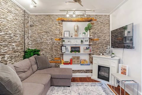 Exposed stone, curated shelves, and a flickering fireplace—this room was made for relaxing in style. The beautiful open shelving gives you WiFi info, cozy touches, and classic board games... all at your fingertips.