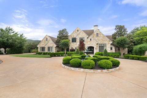 Elegant stone exterior with manicured landscaping and private entry.