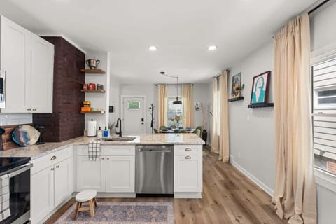 Walking into this kitchen feels like stepping into a Pinterest board - white cabinets and hardwood floors that make you want to cook up a storm in style! ✨