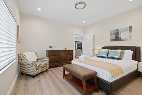 Feel at home in our master bedroom with its cozy lounge chair and convenient ironing station.