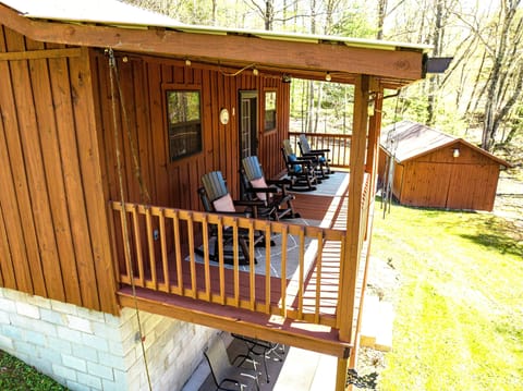 The upper balcony view with rocking chairs, facing the backyard view
