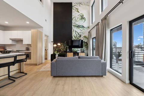 Bright 2-story condo with an open-concept kitchen + living room, space for Murphy beds, and huge windows for natural light. Plus a full downstairs bathroom—perfect for groups and easy, comfortable stays!