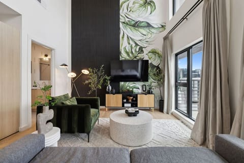 Bright 2-story condo with an open-concept kitchen + living room, space for Murphy beds, and huge windows for natural light. Plus a full downstairs bathroom—perfect for groups and easy, comfortable stays!