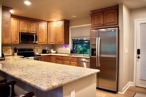 Full size fridge and freezer with filtered water and ice easily accessible.