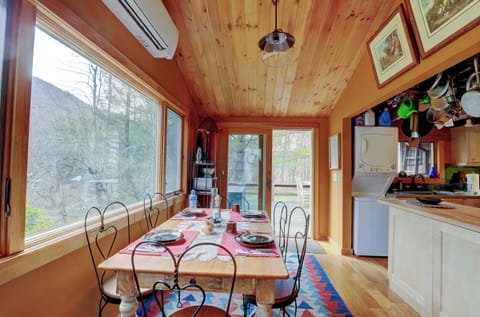 Dining area with sliders to the open deck and kitchen island on the right