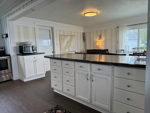 Plenty of storage in the kitchen island, stocked with cooking & serving supplies