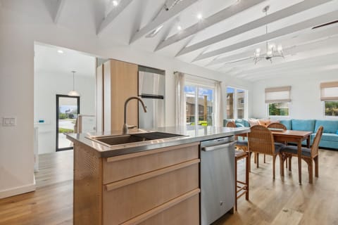 2nd floor kitchen w/view of front entry, sliding door to deck and living room.