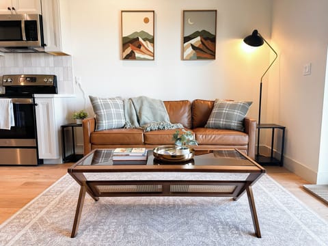 Living area complete with firm sofa, end tables and a coffee table.