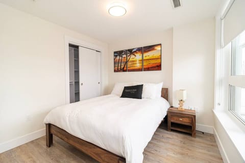 Rest in a cozy queen bed with fresh linens and city views.