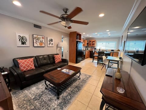 Open plan Living room with dedicated work space and 55 inch Roku smart TV. 