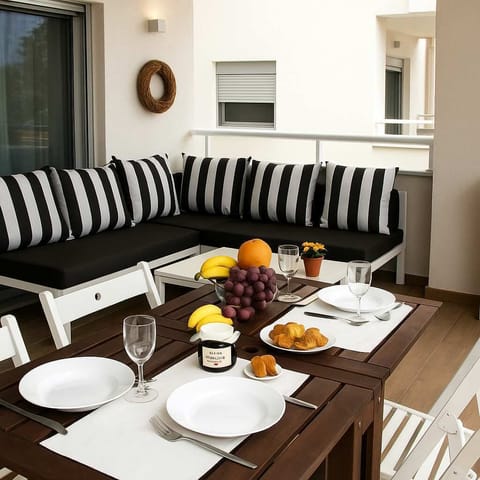 Shaded outdoor dining – Built-in sofa corner with breakfast setup under shade.

