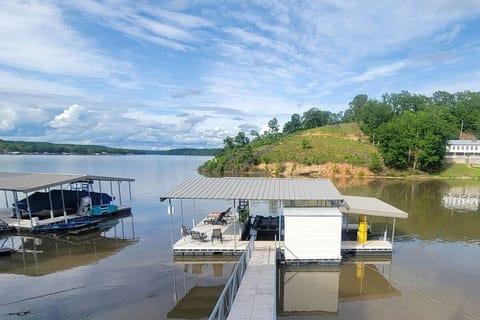 The best water for lake life enjoyment! Deep water cove with amazing dock, kayaks, swim mat, plus ample uncovered boat docking and two covered wave runner slips (one with lift) with room for more.