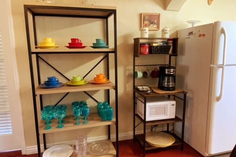 Coffee bar and a rack of extra dishes and glassware for any gathering.