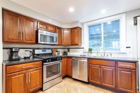 Spacious full kitchen featuring stainless steel and modern appliances.