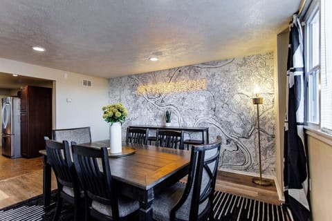 A stylish 6-seater dining table set against a backdrop of neutral tones, featuring modern chairs and a simple centerpiece for an intimate dining experience.