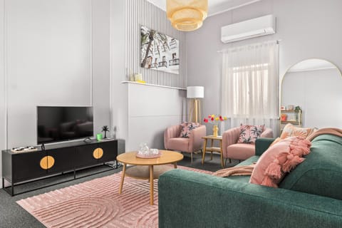 Cosy lounge room with oversized lounge, armchairs & stools for extra seating. 