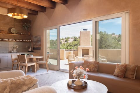 The living, dining, and kitchen have 12-foot ceilings and mountain views.