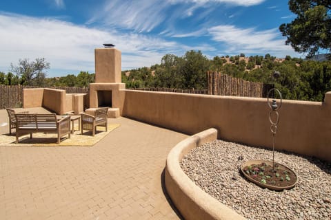 The house has a small fenced back yard beyond the patio.