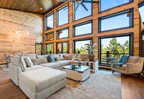 This spacious living room is perfect for relaxing with family. The warm wood paneling adds a charming touch.
