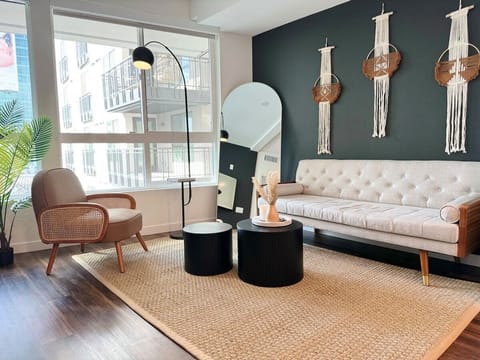 Modern BoHo Style Apartment with a stunning pool and city view  Living room with a sofa and a 55" Smart TV (Netflix, Hulu, and Disney+, we logged them remotely) included for free.