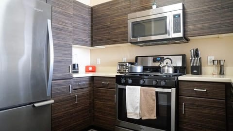 Modern luxury meets practicality in our fully equipped kitchen featuring stainless steel appliances, which are ideal for extended stays.