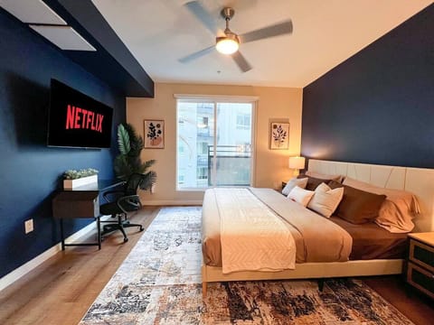 Modern Mid-Century Style Apartment  Living room with a sofa bed and a 55" Smart TV (Netflix, Hulu, and Disney+, we logged them remotely) included for free.