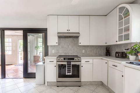 Kitchen includes new stainless steel appliances and access to sun room area