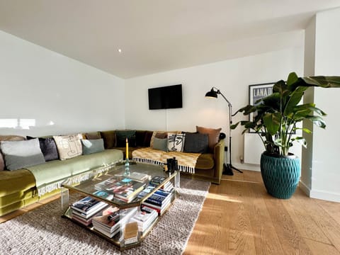 Bright open plan lounge with L shaped sofa, perfect for those nights in