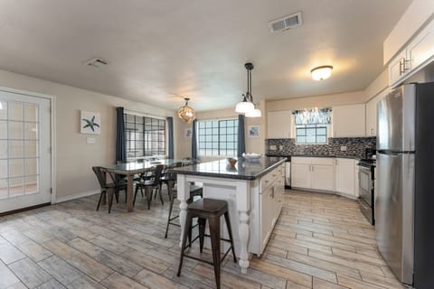 Our open kitchen looks into the dining and living areas, making entertaining and connecting as easy as a walk on the beach!