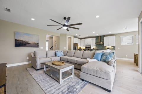 Living room with overstuffed couch and 75" LED TV