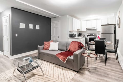 Open-concept living and dining area with modern furnishings and a fully equipped kitchen