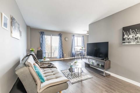 Bright Living Room With Balcony Access And Smart TV