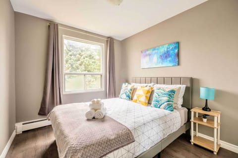 Bright Bedroom With A Queen-Sized Bed And A Large Window Bringing In Natural Light