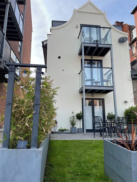 Home exterior with garden, patio and balconies