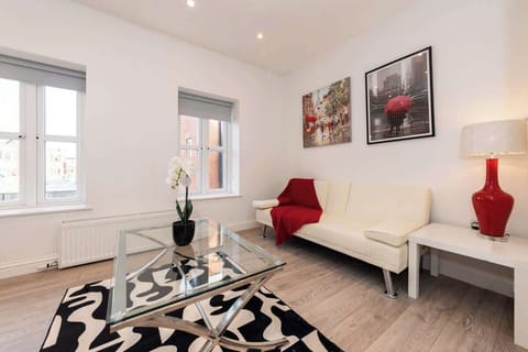 Vibrant and contemporary living space with bold decor , natural light, and a cozy dining area perfect for relaxing or entertaining and a cozy sofa to relax on after work.
