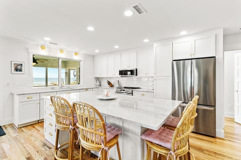 Large kitchen island with bar seating for four.  Great space for meal prep and gathering.