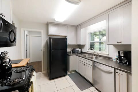 Kitchen is equipped with appliances including full size fridge, oven, stove, microwave, dishwasher, toaster oven, and coffee maker