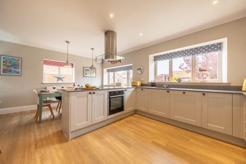 Ground floor: Kitchen/dining with electric oven and induction hob, fridge/freezer, dishwasher and microwave