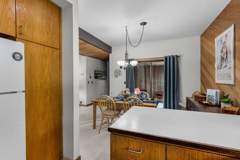 Your cozy alpine kitchen flows seamlessly into the dining area, where warm wood tones and mountain charm create the perfect setting for memorable meals.