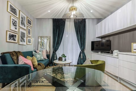 Living Room at Mon Tresor: Elegant living room with stylish décor, cozy seating, and a flat-screen TV, perfect for relaxing after a day out